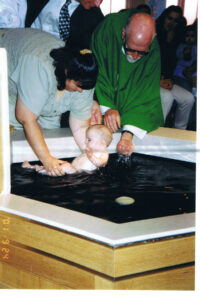 Fr. John baptizes Zachary, first grandchild